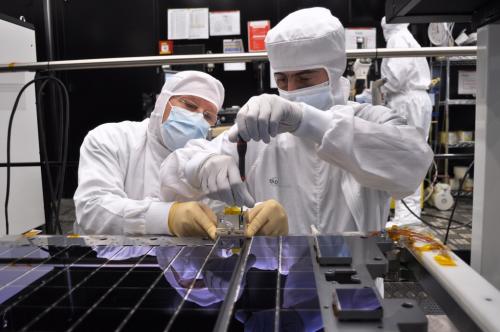 A total of 106 CCDs make up Gaia's focal plane. Technicians from Astrium France, the Gaia mission's prime contractor, are seen here carefully bolting and aligning the CCDs onto the CCD support structure (CSS), at the company's facility in Toulouse. The CSS (the grey plate underneath the CCDs) weighs about 20 kg and is made of silicon carbide (SiC), a material that provides remarkable thermal and mechanical stability. Gaia's CCDs are provided by e2v Technologies of Chelmsford, UK. Each CCD measures 6 cm × 4.7 cm, with a thickness of only a few tens of microns. Precisely fitted together on the CSS, the gap between adjacent CCD packages is about 1 millimetre. ***** 22 April 2011 ***** credits: Astrium