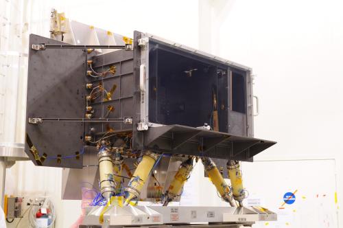This photograph shows the Gaia focal plane assembly (FPA) structural model (SM) in the cleanroom at INTESPACE, Toulouse, France. In October 2010, the FPA SM underwent a series of mechanical tests that demonstrated that it is structurally fit for flight. In the photograph, the black panels are radiators, used for passive cooling of the focal plane CCDs. The focal plane is inside the approximately 1-metre-wide box-shaped radiator, and behind a clear protective cover placed at the front of that radiator. The silver-coloured panel (visible behind the FPA) is used for passive cooling of the FPA electronics that are also housed behind the FPA. The six yellow 'tubes' underneath the FPA are the FPA support struts that are used to mount the FPA on the Gaia torus. ***** 19 November 2010 ***** credits: Astrium