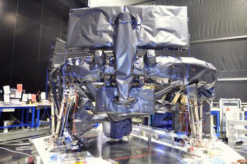 Fully-integrated Gaia Protoflight Payload Module with all the Multi-Layer Insulation (MLI) installed, with the exception of the covering for the bipods. The optical bench is now shrouded with MLI. Nearest to the camera, the rear of one of the primary mirrors and one of the tertiary mirrors are visible. Beneath the tertiary (smaller) mirror, the Radial Velocity Spectrometer (RVS) can be seen. To the right of the RVS is the Focal Plane Assembly (FPA) with its Charge-Coupled Device (CCD) sensors (blue). The focal plane array, with 106 CCDs, a total of almost 1 Gigapixels, is the largest ever developed. ***** 11 August 2012 ***** credits: Astrium SAS