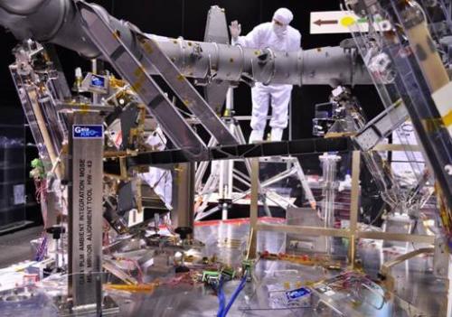 View of the PayLoad Module (PLM) in the clean room of Astrium in Toulouse. The M5 and M6 45-degree flat folding mirrors are visible on the left. The M4 beam-combiner mirrors are visible to the right of the legs of the person. ***** 27 April 2011 ***** credits: Astrium