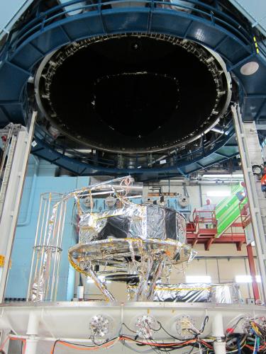 Gaia Service Module (SVM) ready for thermal balance/thermal vacuum testing in the SIMLES chamber at Intespace Toulouse. The SVM is mounted on a tripod; the gantry on the left carries instrumentation cables to one of the interfaces on the base of the chamber. Underneath the SVM, the Phased Array Antenna (PAA) test heater and the bundle of test cables coming from the various temperature sensors, test heaters and from the PAA RF test ports can be seen. This large bundle of PAA cables is covered by Multi-Layer Insulation (MLI) to control its temperature and can be seen on the picture as a silver cylinder going to the right and then through the bottom floor of the chamber. The main body of the chamber can be seen at the top of the picture. ***** 22 July 2012 ***** credits: Astrium SAS